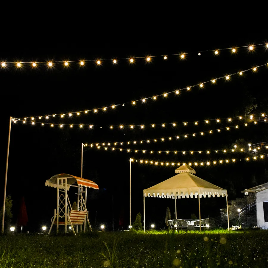 Tents at night with warm string lights